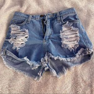 Fashion nova ripped blue jeans.